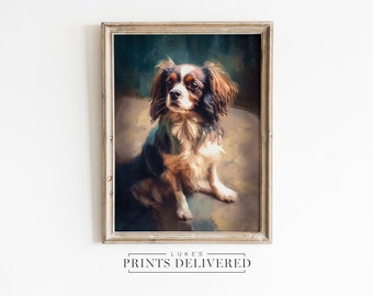 May include: A painting of a brown and white Cavalier King Charles Spaniel dog sitting on a blue and green background. The dog is looking to the left of the image. The painting is framed in a light brown frame.