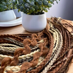 Brown-gray braids, soft and light with the addition of white braids, black braids