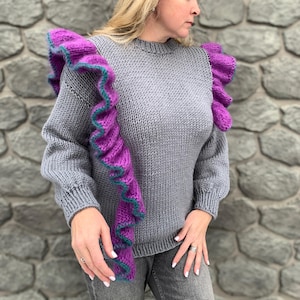 Handknitted women&#39;s wool jumper with ruffles