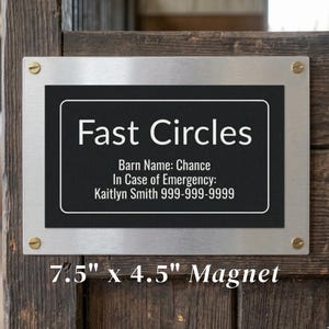 May include: A rectangular 7.5 inch by 4.5 inch metal sign with a black center and white border. The text reads: Fast Circles, Barn Name: Chance, In Case of Emergency: Kaitlyn Smith 999-999-9999. It is secured with four gold-colored screws at the corners.