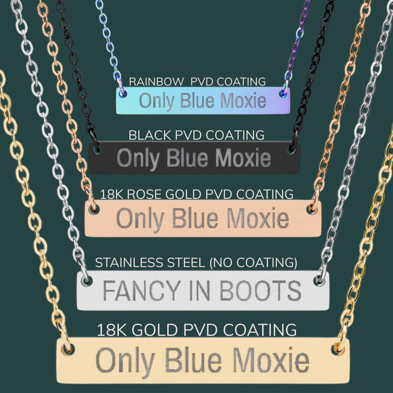 May include: A collection of necklaces with bar pendants in various finishes, including rainbow, black, rose gold, stainless steel, and gold. Each pendant features engraved text, with "Only Blue Moxie" and "FANCY IN BOOTS" visible.