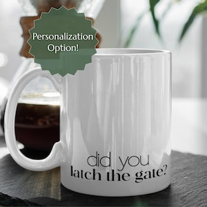 May include: White ceramic mug with the text "did you latch the gate?" in black. The mug has a large handle and a cylindrical shape. A green and white label that says "Personalization Option!" is in the background.