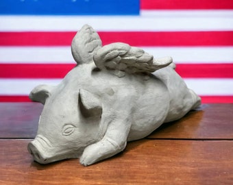 When pigs fly statue Laying pig with wings figurine Outdoor or indoor sculpture Made in USA