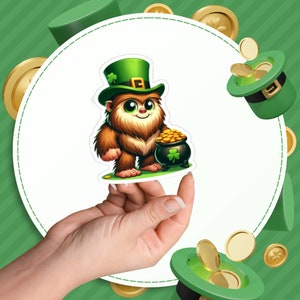 May include: A brown and white furry creature wearing a green leprechaun hat and holding a pot of gold. The creature is holding a pot of gold with a shamrock on it.