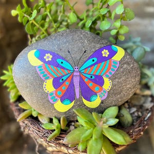 Butterfly rock. Painted on a beautiful stone, this colorful guy is ready to land on your porch or flower garden. Perfect for a large planter