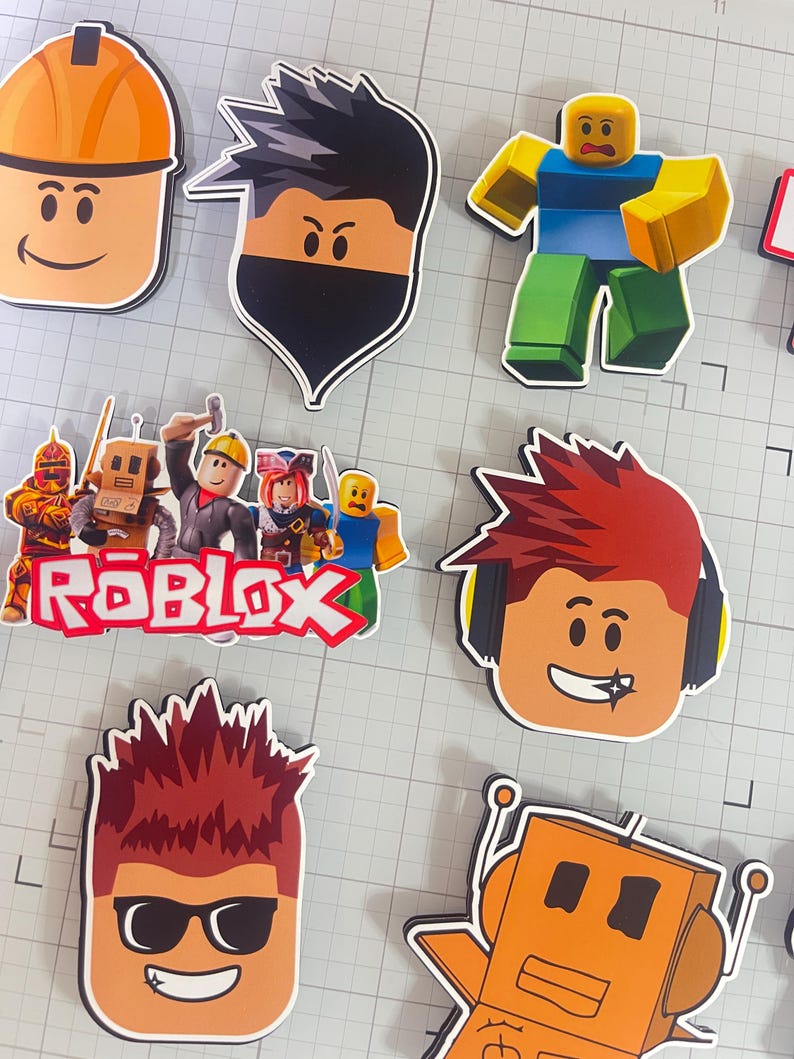 Set of 12 Roblox cupcake toppers featuring popular characters, logos, and icons from the game. Includes layered paper designs with vibrant colors, perfect for gamer-themed birthday parties, cupcakes, and dessert table decor. Ideal for Roblox fans and video game celebrations.