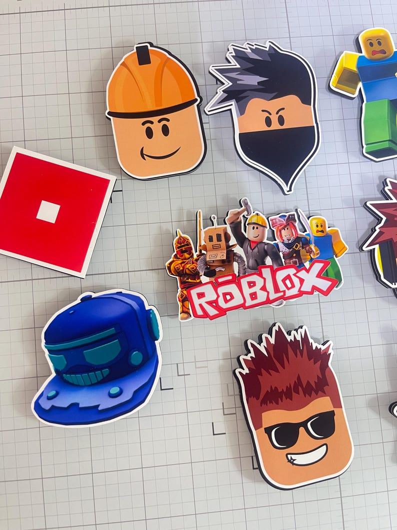 Set of 12 Roblox cupcake toppers featuring popular characters, logos, and icons from the game. Includes layered paper designs with vibrant colors, perfect for gamer-themed birthday parties, cupcakes, and dessert table decor. Ideal for Roblox fans and video game celebrations.