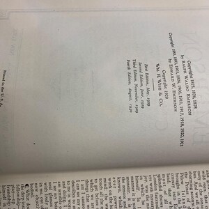 May include: Open book page with text including copyright information for a book by Ralph Waldo Emerson and Edward W. Emerson. The text includes the publisher, edition dates, and "Printed in the U.S.A."