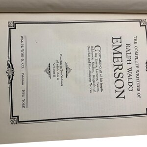 May include: Open book page featuring the title "The Complete Writings of Ralph Waldo Emerson." The text includes "Volume II" and the publisher's name, "WM. H. Wise & Co., Publishers, New York."