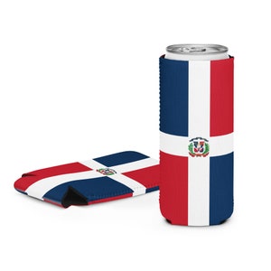 May include: Two drink koozies, one upright and holding a can, the other flat. Both display the Dominican Republic flag: a white cross dividing the surface into red and blue rectangles, with a coat of arms at the centre. The koozies are designed to keep drinks cool.