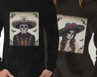 May include: Two long-sleeved shirts with a Day of the Dead theme. The shirts feature a skeleton wearing a sombrero and a skeleton woman wearing a sombrero with flowers. The shirts are black with a vintage-style background.