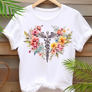 May include: White t-shirt with a floral design featuring a medical caduceus symbol in the center.