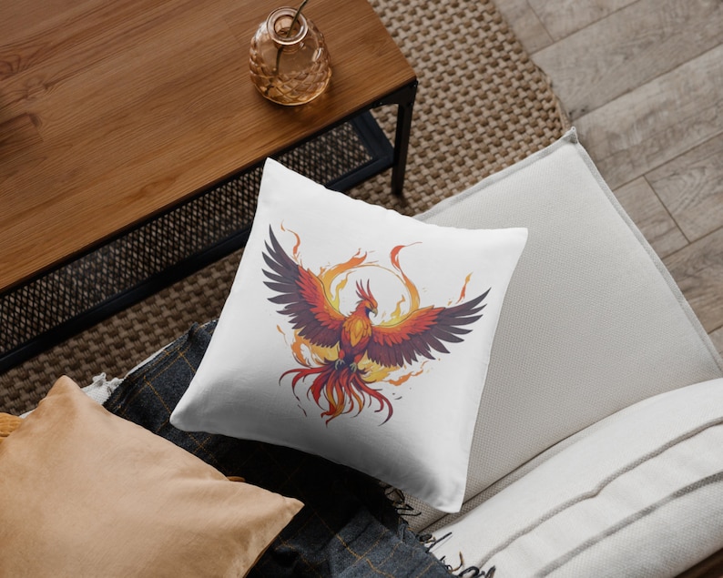May include: White throw pillow with a colorful illustration of a phoenix rising from flames.