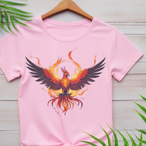 May include: Pink t-shirt with a graphic of a phoenix rising from flames.