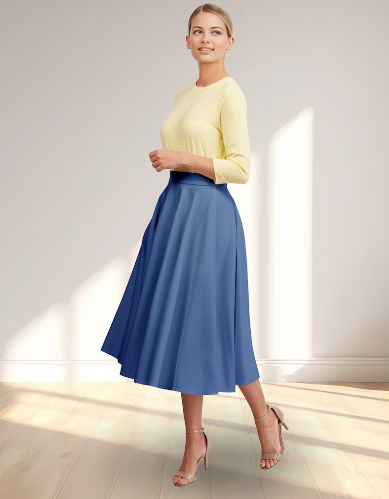 May include: A woman wearing a yellow top and a blue midi skirt. The skirt is a-line and has a high waist.