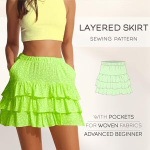 May include: A layered skirt sewing pattern with pockets for woven fabrics. The pattern is for an advanced beginner and features a bright green skirt with a white polka dot pattern.