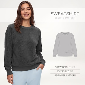 May include: A dark gray crew neck sweatshirt with an oversized fit. The sweatshirt has a textured, fuzzy appearance and is paired with light blue pants. The image also includes a sewing pattern illustration and text that reads "SWEATSHIRT SEWING PATTERN".