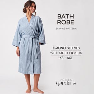 May include: A light blue bath robe sewing pattern featuring kimono sleeves and side pockets in sizes XS-4XL. The text reads BATH ROBE SEWING PATTERN, KIMONO SLEEVES WITH SIDE POCKETS XS-4XL, and the brand name Pattern Gardens.