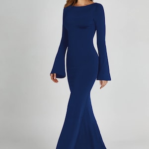 May include: A long, navy blue maxi dress with a fitted bodice and bell sleeves. The dress has a simple, elegant design and is perfect for a formal occasion.
