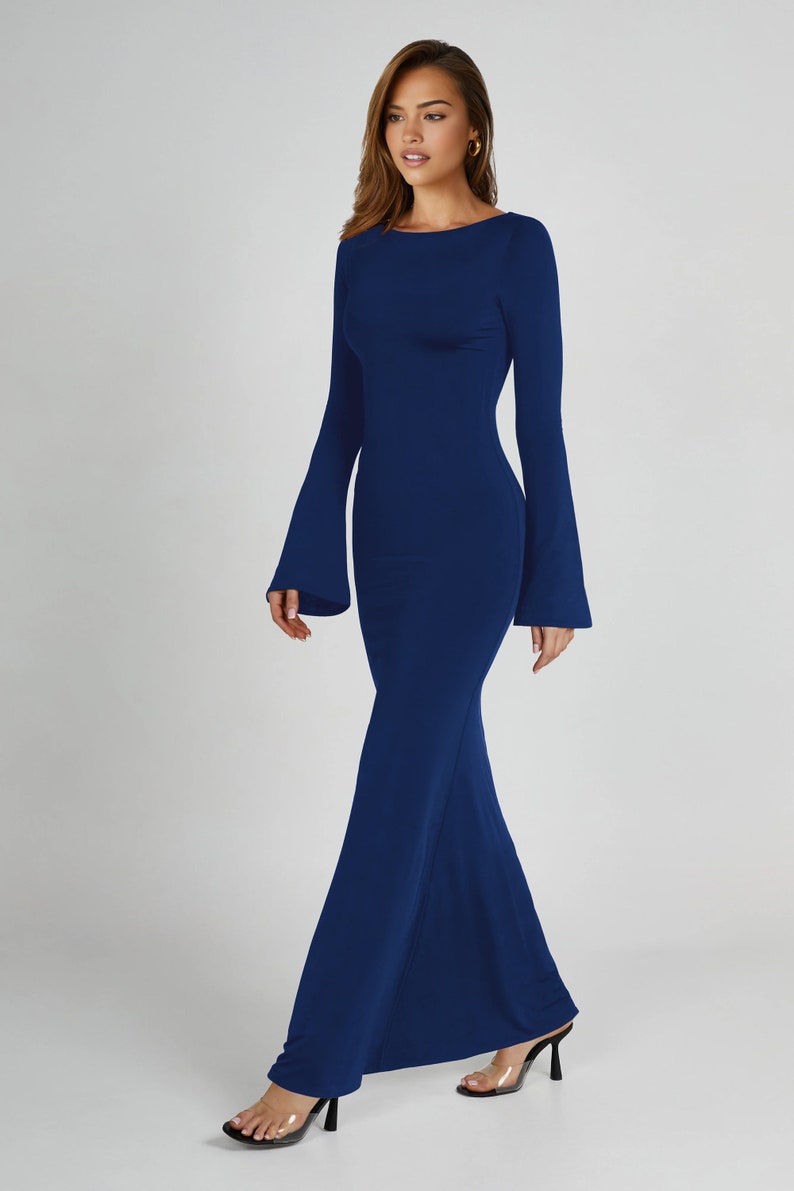 May include: A long, navy blue maxi dress with a fitted bodice and bell sleeves. The dress has a simple, elegant design and is perfect for a formal occasion.