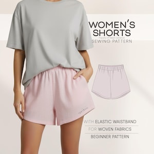 May include: A person wearing a grey t-shirt and pink shorts. The shorts have an elasticated waistband and are designed for woven fabrics. The image includes a sewing pattern for women's shorts.