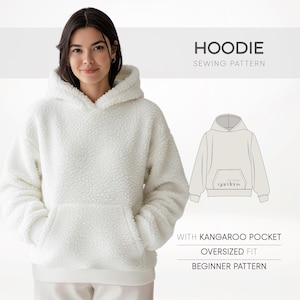 May include: A woman wearing a white, oversized hoodie with a kangaroo pocket. The image includes the text "HOODIE SEWING PATTERN" and details: "WITH KANGAROO POCKET", "OVERSIZED FIT", and "BEGINNER PATTERN".