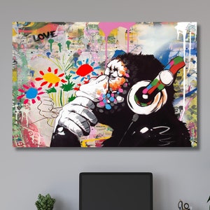 May include: A colorful abstract painting of a gorilla wearing headphones and holding a bouquet of flowers. The background is a collage of different textures and patterns, including graffiti and text. The word "LOVE" is visible in the upper left corner of the painting.
