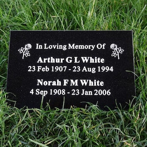 May include: Black granite memorial plaque with white lettering. The inscription reads "In Loving Memory Of Arthur G L White 23 Feb 1907 - 23 Aug 1994 Norah F M White 4 Sep 1908 - 23 Jan 2006".