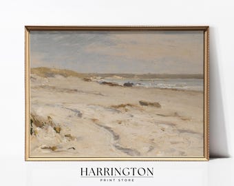 May include: A framed painting depicting a beach scene with a pale blue sky, white sand, and a tranquil sea. The painting is presented in a gold frame.