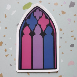 May include: A sticker of a stained glass window with three panels in pink, purple, and blue. The window is in the shape of an arch.