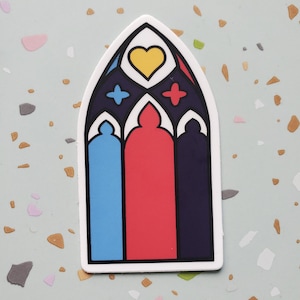 May include: A sticker of a stained glass window with a heart in the center and blue, red, and purple panels.