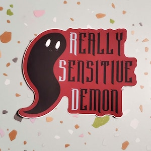 May include: A red sticker with a black ghost and the text "REALLY SENSITIVE DEMON" in white letters.