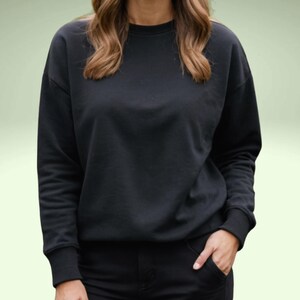 May include: A black long-sleeved sweatshirt with a crew neck.