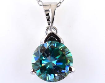 May include: A silver pendant necklace with a large, round, blue and green moissanite gemstone.
