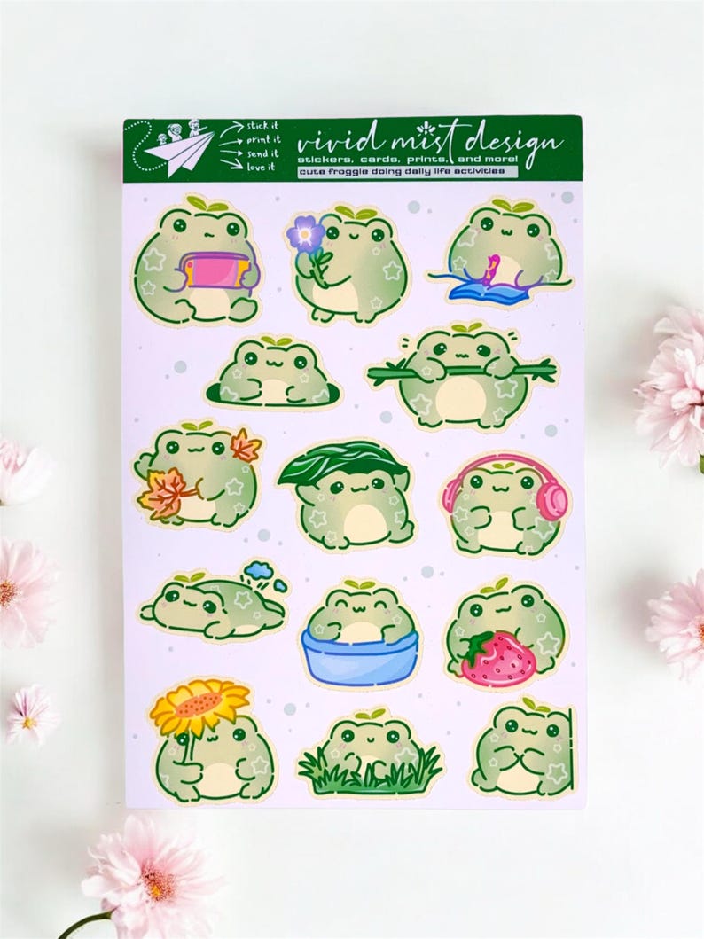 A pastel-themed 4×6 sticker sheet featuring an adorable collection of chubby green cartoon frogs, each illustrated in a soft, rounded kawaii style with gentle outlines and subtle sparkly details on their bodies. The sticker sheet is photographed flat on a clean white background, framed by soft pink flowers placed around the edges, giving the image a cozy, cheerful stationery aesthetic.