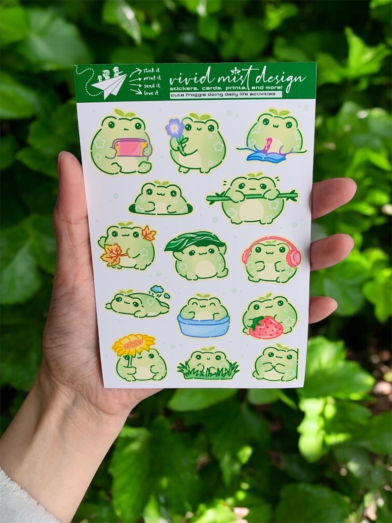 The frogs are shown doing everyday joyful activities: one frog holds a small book or notebook, another presents a tiny flower with a sweet smile, while another lounges peacefully with a relaxed expression. Several frogs are interacting with nature—one hides in grass, another holds autumn leaves, one wears a leafy “hat,” and another stands proudly holding a bright sunflower. There is also a frog soaking happily in a small blue tub, adding a cozy self-care vibe to the collection.