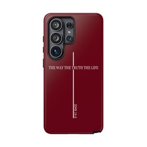May include: A deep red smartphone case featuring a vertical white line forming a cross shape. The text THE WAY THE TRUTH THE LIFE is printed in white horizontally across the cross, with the reference JOHN 14:6 printed vertically below it.