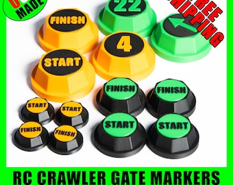 Op de afbeelding: Een set van 10 RC crawler poortmarkeringen in zwart, groen en geel. De markeringen bevatten de woorden "Start" en "Finish" en de nummers 4 en 22. De markeringen zijn ontworpen voor RC crawlers op schaal 1:10, 1:18 en 1:24.
