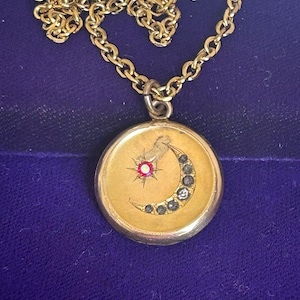 Antique gold filled Victorian art nouveau crescent moon and star locket with paste AB red stones on gold tone chain