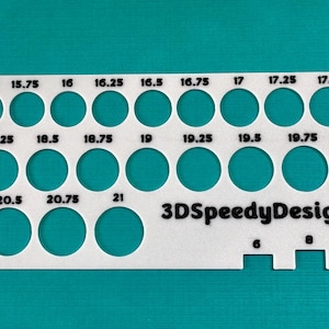 May include: White plastic gauge with a series of circles labeled with sizes from 15 to 21 inches. The gauge also has a ruler with markings for 6, 8, and 10 inches. The text "3DSpeedyDesigns" is printed on the gauge.