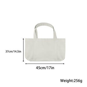 May include: A light-colored tote bag with two handles. The bag is 17 inches wide and 14.5 inches tall. The weight of the bag is 256 grams.