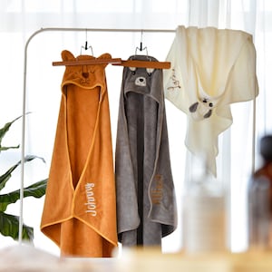 Personalised baby bath towel with adorable hooded animal design and custom embroidered name, ideal gift for new parents and baby showers