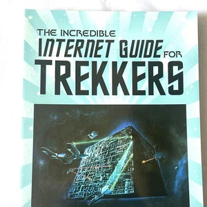 May include: A book cover with a blue and white background featuring a spaceship and a large, dark, cube-shaped structure. The title of the book is "The Incredible Internet Guide for Trekkers" and the author is "James R. Flowers, Jr."