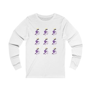May include: White long-sleeved t-shirt with a repeating pattern of purple cartoon characters riding unicorns and holding yellow, white, and purple flags.