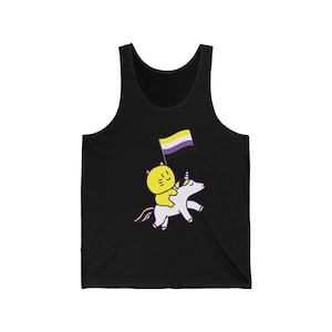May include: A black tank top with a yellow cat riding a white unicorn. The unicorn is holding a yellow, white, and purple flag.