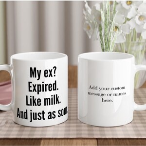Pode incluir: Duas canecas de cerâmica brancas. Uma caneca tem o texto "My ex? Expired. Like milk. And just as sour." A outra caneca tem o texto "Add your custom message or names here."