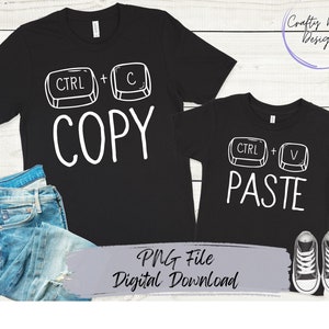 May include: Two black t-shirts with white text and graphics. The larger shirt says "CTRL + C COPY" and the smaller shirt says "CTRL + V PASTE".