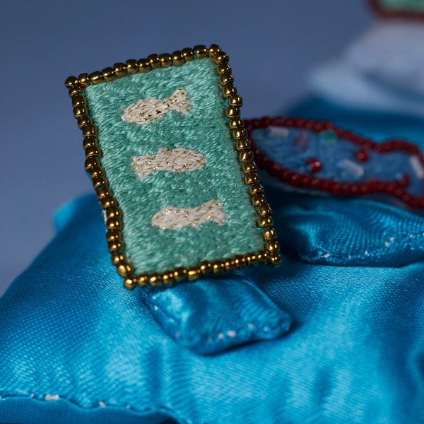 Rectangular hand-embroidered fish rings