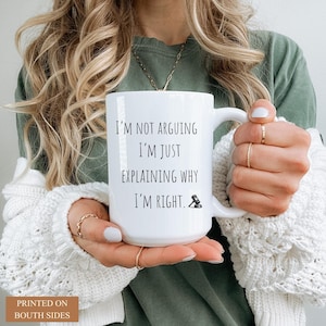 Pu&ograve; includere: Tazza in ceramica bianca con la scritta "I'M NOT ARGUING I'M JUST EXPLAINING WHY I'M RIGHT" in nero. La tazza presenta anche una piccola icona di martelletto. La tazza &egrave; tenuta da una persona che indossa un maglione bianco.