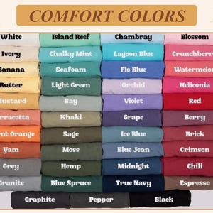May include: A color chart titled COMFORT COLORS displaying forty-four folded fabric swatches in various shades. The grid includes labels such as White, Ivory, Banana, Butter, Mustard, Terracotta, Burnt Orange, Yam, Grey, Granite, Graphite, Pepper, and Black.
